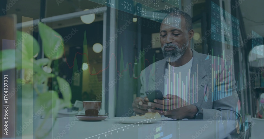 Fototapeta premium Analyzing financial charts, male professional holding smartphone at coffee shop, with coffee cup