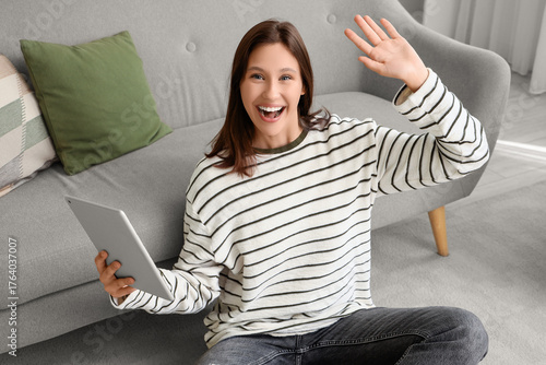 Happy young woman with tabl...