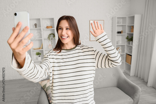 Happy young woman with mobi...
