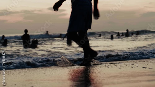 早朝の海で戯れる人々