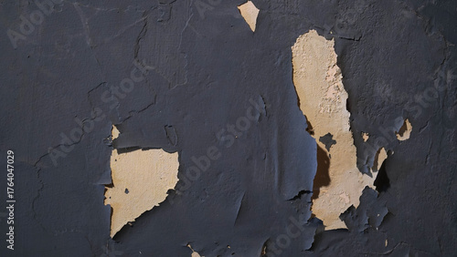 Wall with peeling and damaged black paint surface