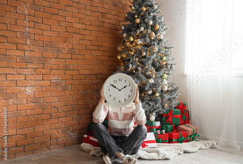 Woman with clock sitting ne...