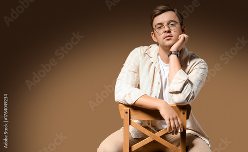 Stylish young man sitting i...
