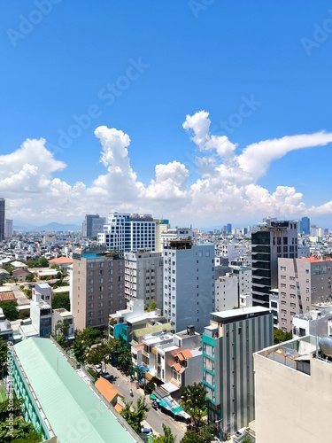 Wallpaper Mural DA NANG, VIETNAM – SEPTEMBER 15, 2025: High-angle view of the urban skyline and mixed commercial buildings under a sunny sky Torontodigital.ca