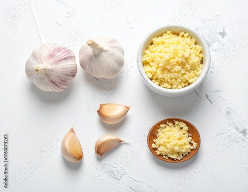 minced garlic and garlic cloves. Minced garlic on white table top