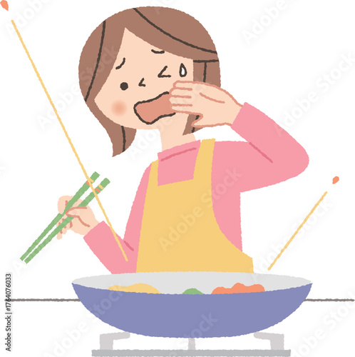 料理中に油がはねて困る女性