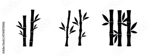 Set of three simple black bamboo stalks with leaves in stylized graphic form