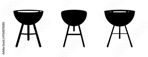 Three silhouette charcoal kettle barbecue grills with tripod legs ready for outdoor cooking