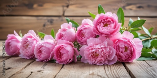 Fototapeta Naklejka Na Ścianę i Meble -  Pink peonies in full bloom on a rustic wooden table