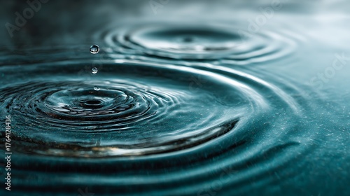 Water Droplets Falling Into Rippling Water Surface, Creating Concentric Circles