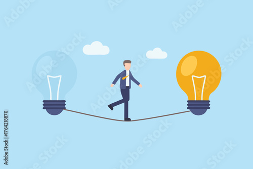 Businessman walking on a tightrope between two light bulbs symbolizing ideas and innovation