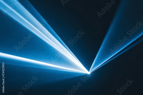 Abstract glowing blue laser light beams converging and radiating from a central point in darkness