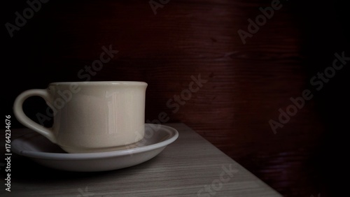 Obraz na plátně A photo of a coffee cup placed on a wooden table