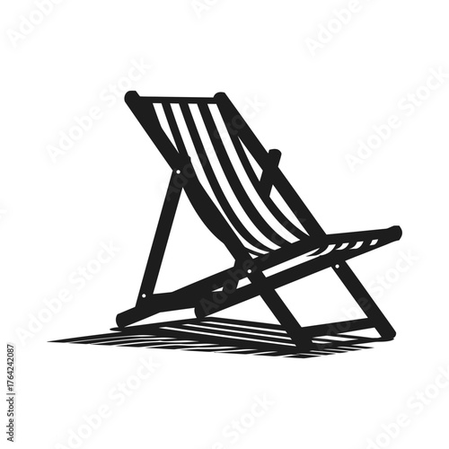 Classic striped deck chair on a sunny beach casting a shadow