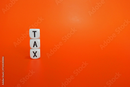 Tax Season: tax time reminder on the red background digitally generated image stock photo copy space white dice spelling TAX vertically against a vibrant orange background concepts related to tax seas