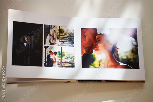  an open photo book with wedding photos on a white table