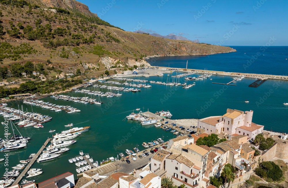 Fototapeta premium Aerial view of Castellammare del Golfo, a town located in the province of Trapani, Sicily, Italy. It has a small marina overlooking the Tyrrhenian Sea, crowded with many boats every summer.