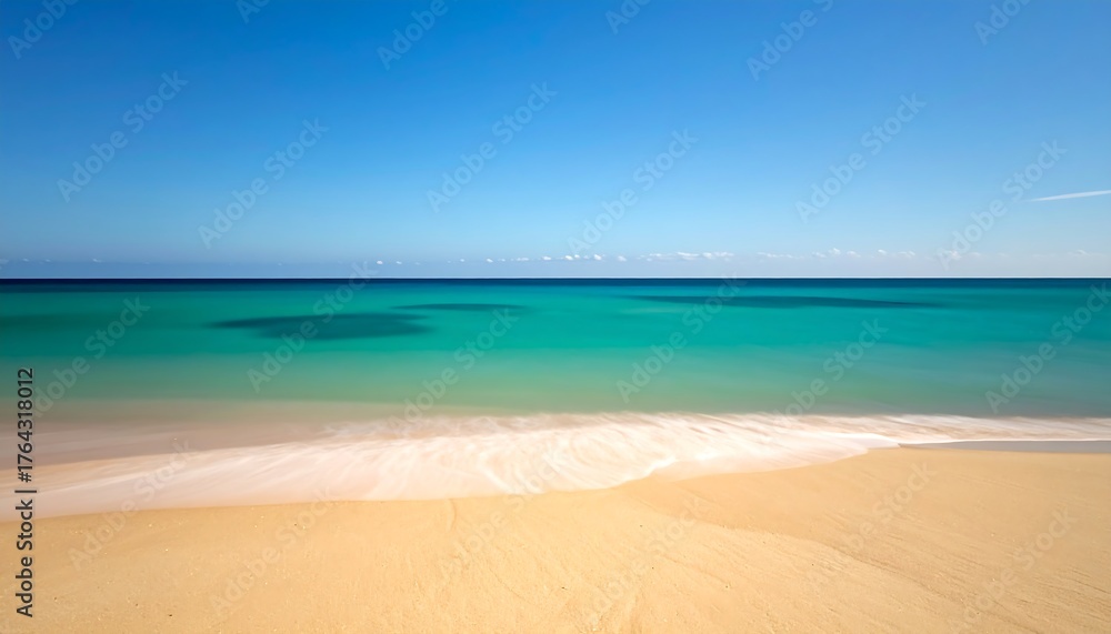 Fototapeta premium A sun-drenched, pristine beach with turquoise water meets a clear blue sky in a serene, idyllic seascape