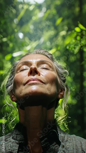 Embracing Tranquility: A woman closes her eyes, basking in the sun's gentle embrace. She radiates serenity as she connects with the natural world.