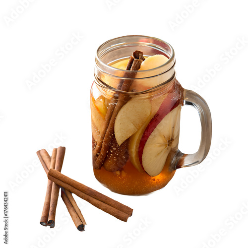 Apple cider with cinnamon sticks and fresh apple slices in a glass jar, cozy autumn drink.