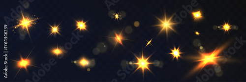 Set of glowing golden light flares and sparkles on dark transparent background.