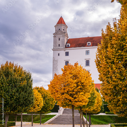Photography Bratislava Castle in Slovakia with trimmed linden trees (Tilia) and boxwood hedges in the baroque garden during autumn