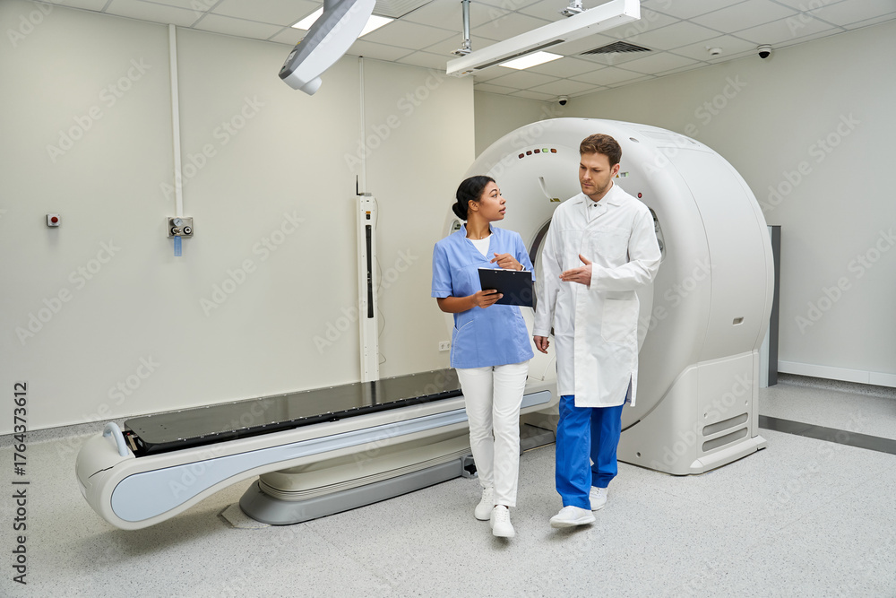Fototapeta premium Doctors collaborate in advanced hospital setting to analyze MRI scan results