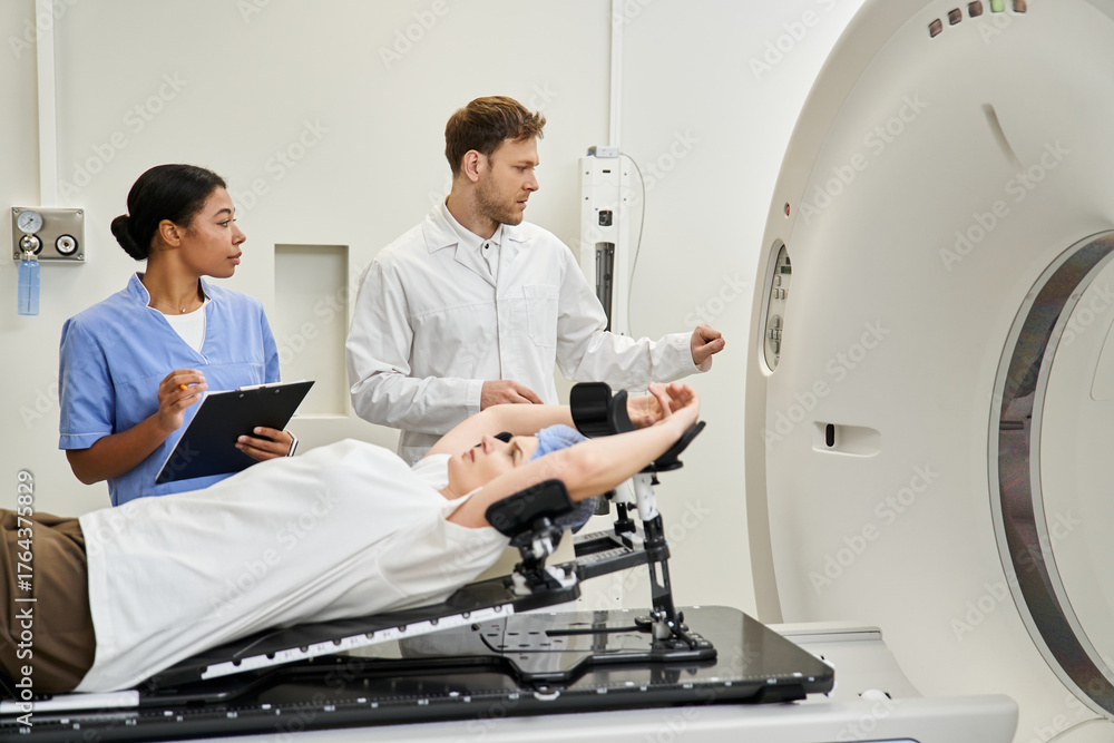 Fototapeta premium Healthcare professionals prepare a patient for an MRI scan in a modern hospital setting