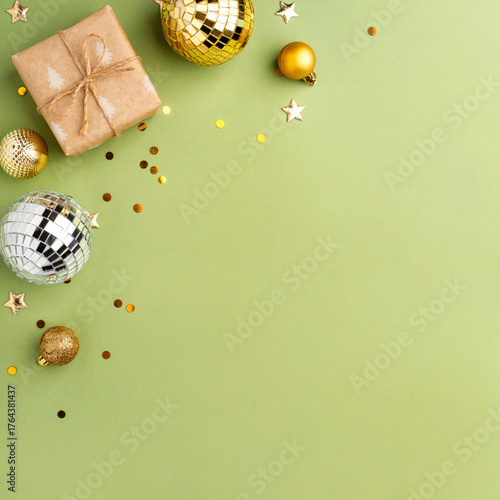Christmas gift with gold ornaments on a green background.