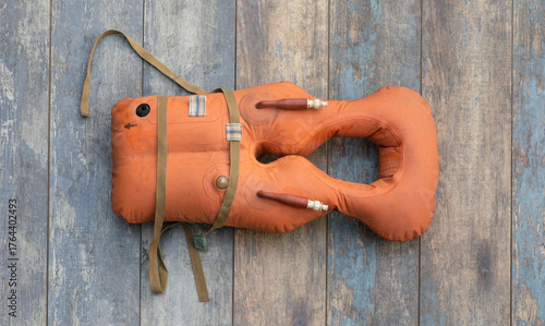 orange life jacket on wooden background
