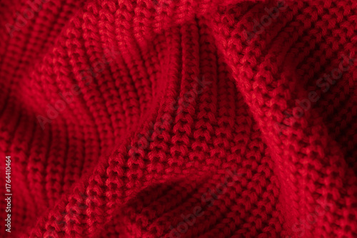 Knitted red background. Close-up. Cozy concept