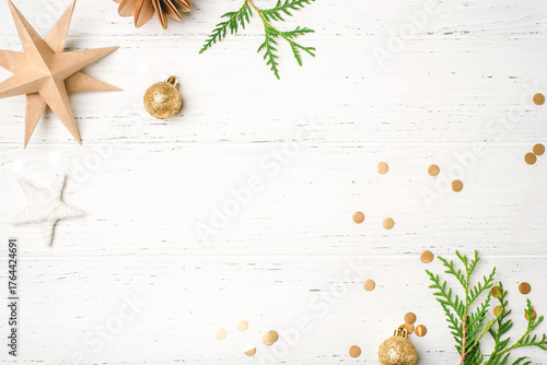 Festive Christmas background with Christmas decorations on white wooden table. Top view. Copy space for text.