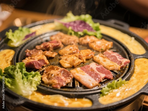 Grilled meat and vegetables on a hot plate with lettuce garnish