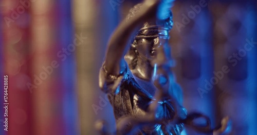 Lady Justice Bronze Statue in front of a bookshelf