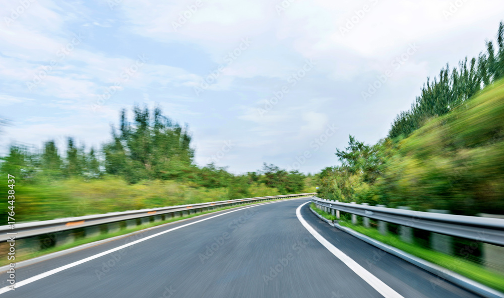 Fototapeta premium Empty curved road in motion blur