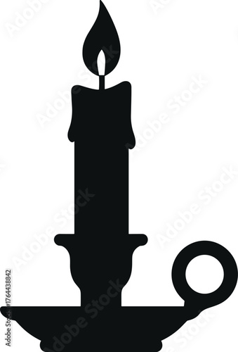 candle burning in a classic holder with soft wax drips silhouette