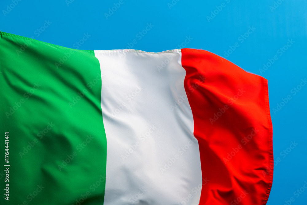 Fototapeta premium Italian flag waving on blue background