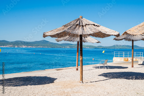 The famous Kolovare beach with umbrellas on vacation in Zadar, Croatia.