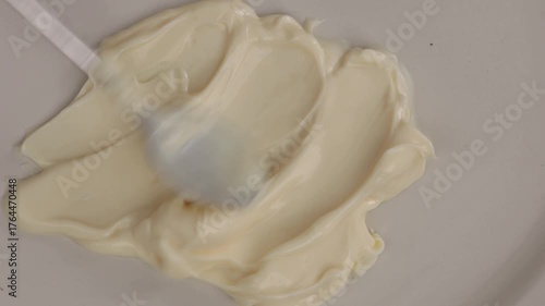 pread mayonnaise texture with a spoon food on light surface zoom top 