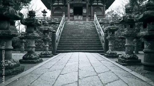 Stone pathway leading to traditional structure with steps and lanterns