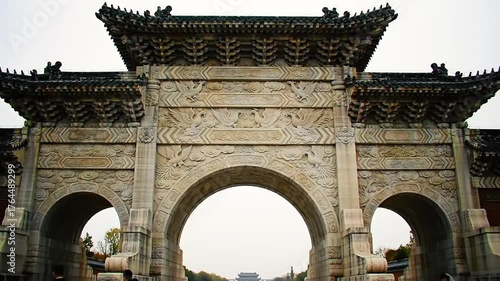 Ancient stone archway structure with ornate carvings and architectural design