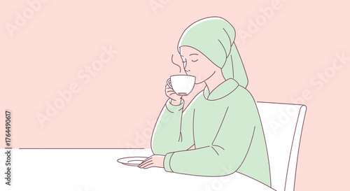 Woman in headscarf enjoying a warm beverage.