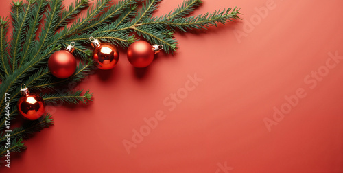 Evergreen Pine Branch with Red Christmas Baubles on Red Background. Holiday Decor Visual for Chrismtas Banners