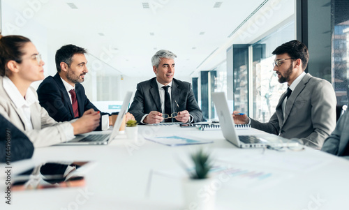 Business team brainstorming in executive office meeting