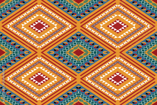 Seamless tribal ethnic geometric pattern featuring diamond shapes in mustard yellow, red, and teal tones. Ideal for textiles, bohemian fashion, ethnic wallpapers, cultural crafts, and decorative fabri