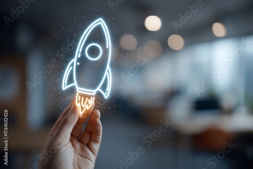Hand Holding a Neon Rocket Illustration in Modern Office