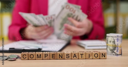 Counting cash for fair compensation while sitting at a desk with bills, coins, and important paperwork