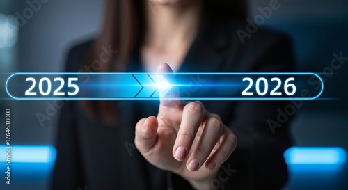 A woman touches a loading bar, transitioning from 2025 to 2026. Progress, future planning, and new year goals. annual planning and business growth