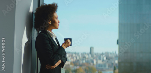 Canvastavla Confident businesswoman with a thoughtful expression standing by a large office