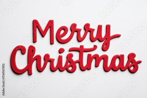 Embroidered red Merry Christmas text in cozy festive design on fabric texture.